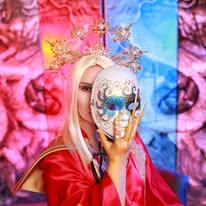 Creative portrait with a decorative mask, golden headdress and red costume